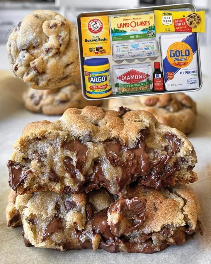 Freshly baked chocolate chip cookies on a cooling rack.