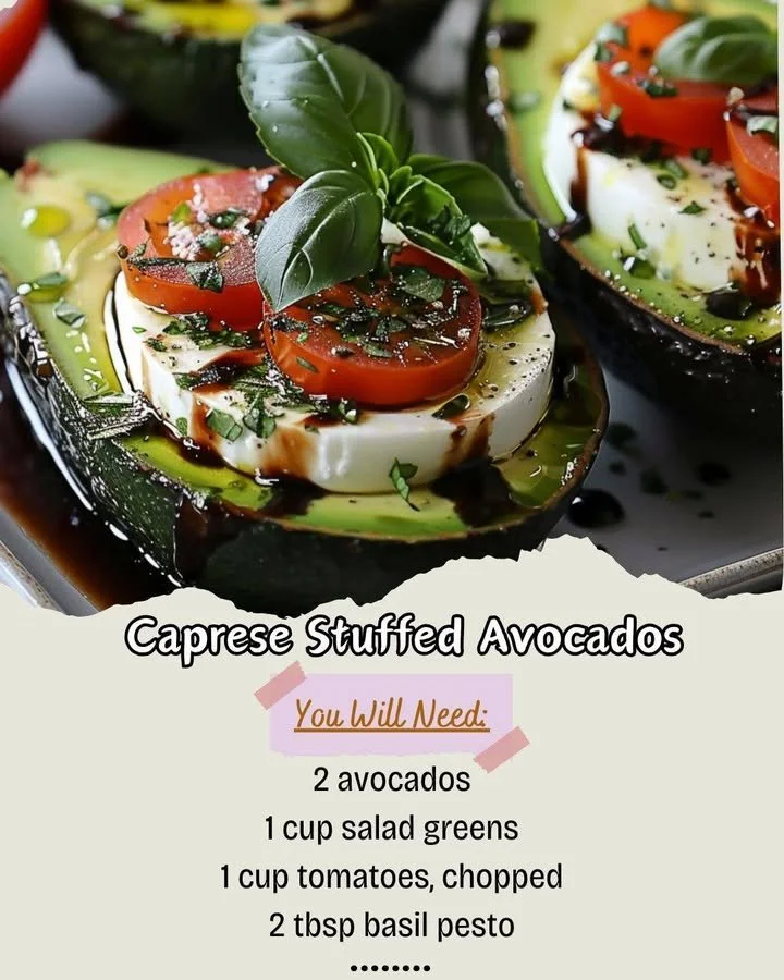 Caprese stuffed avocados with tomatoes, mozzarella, and basil on a plate