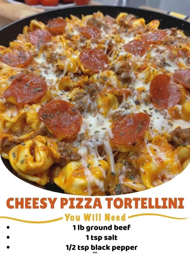 Cheesy pizza tortellini served on a plate with fresh herbs and toppings