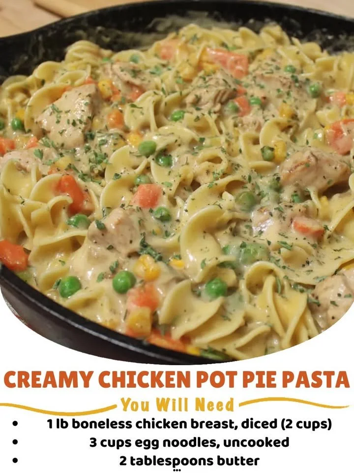 A bowl of creamy chicken pot pie pasta garnished with herbs and vegetables.