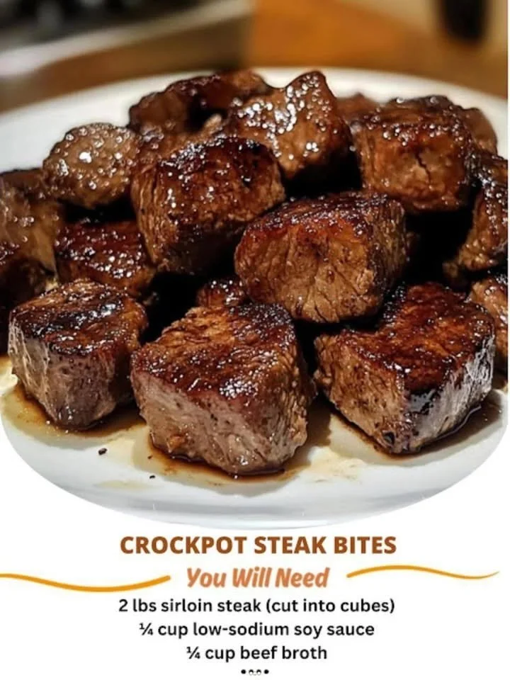 Delicious crockpot steak bites served on a plate with side vegetables.
