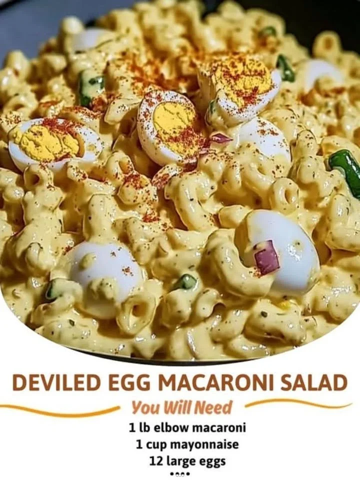 Delicious deviled egg macaroni salad in a bowl garnished with herbs.