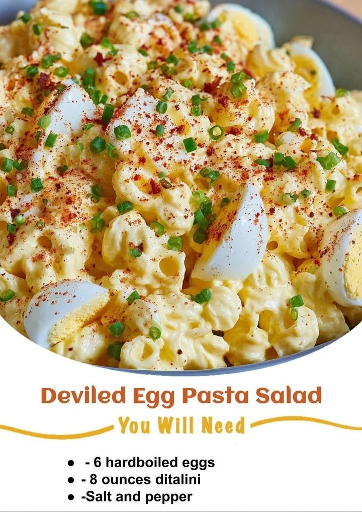 Delicious deviled egg pasta salad served in a bowl with herbs and spices.