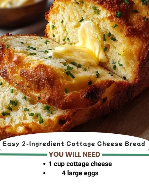 Loaf of easy 2-ingredient cottage cheese bread freshly baked on a wooden cutting board.