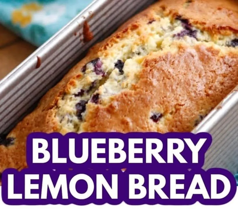 Freshly baked lemon blueberry bread with slices and blueberries on the side.