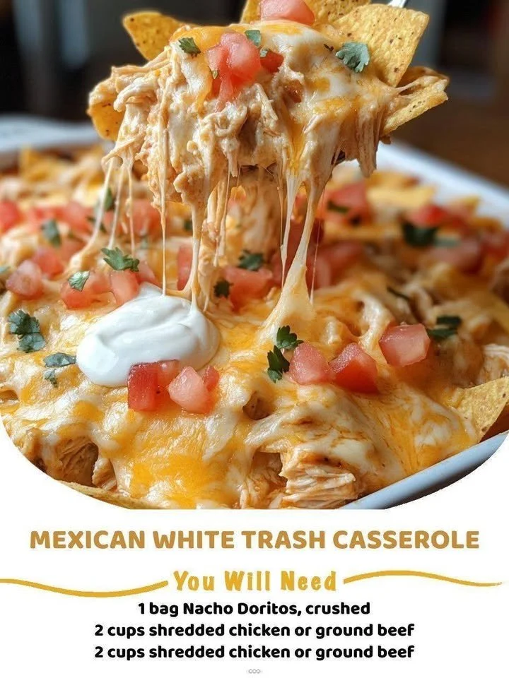 Mexican White Trash Casserole with cheese and toppings in a baking dish