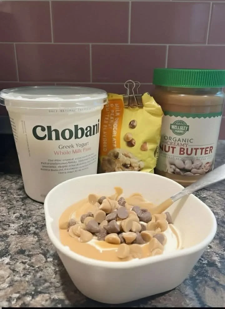 Peanut Butter Greek Yogurt Bowl topped with nuts and fruits