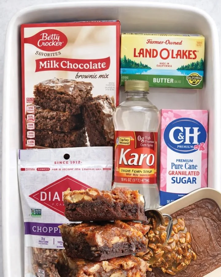 Delicious pecan pie brownies topped with nuts and chocolate drizzle.