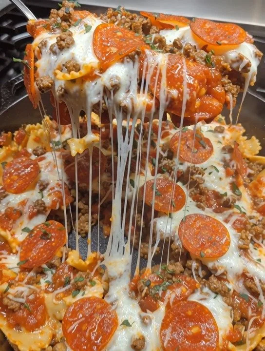 Delicious Pizza Lasagna Skillet Bake topped with melted cheese and fresh basil.