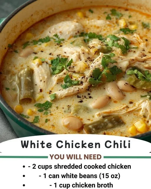 A bowl of White Chicken Chili topped with cilantro and lime wedges