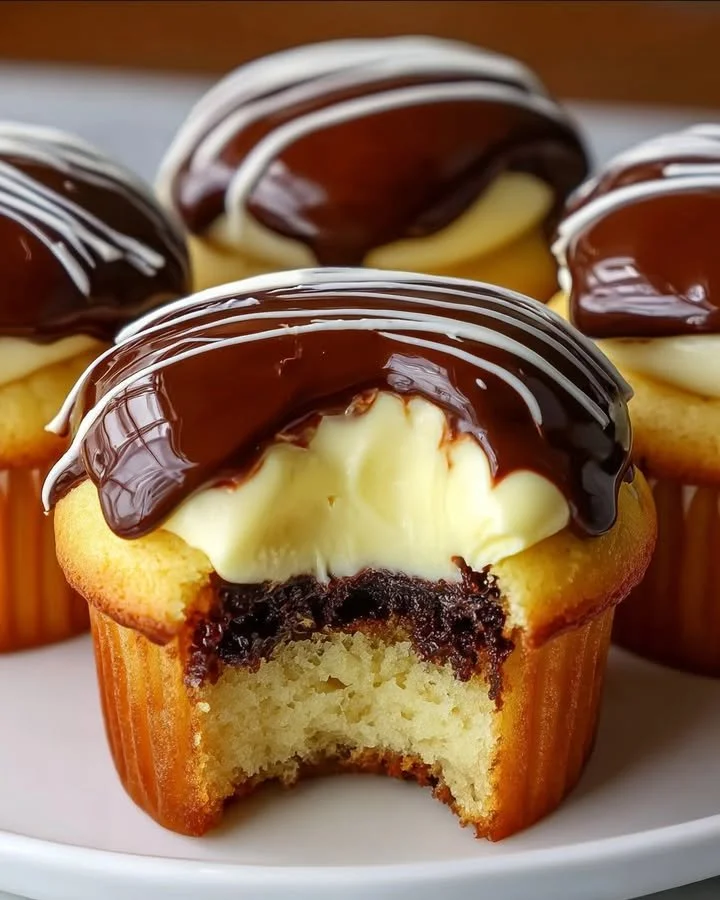 Boston Cream Pie Cupcakes topped with chocolate ganache and vanilla cream