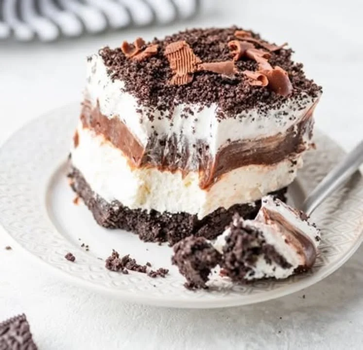 Delicious Chocolate Oreo Cheesecake Lush dessert topped with crushed Oreos.