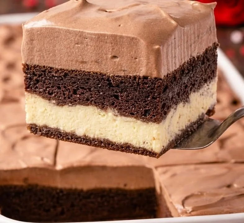 Slice of Italian Love Cake topped with fresh berries and whipped cream.