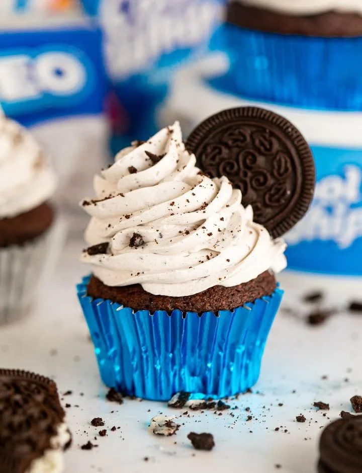 Delicious Oreo cookie frosting spread on a chocolate cupcake