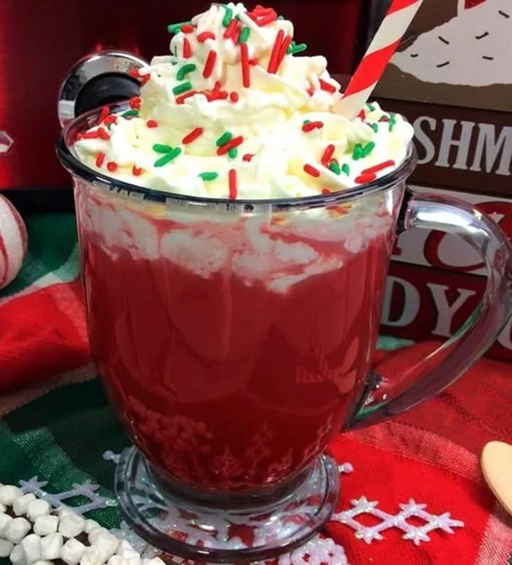 Valentine's Day red velvet hot chocolate topped with whipped cream and sprinkles